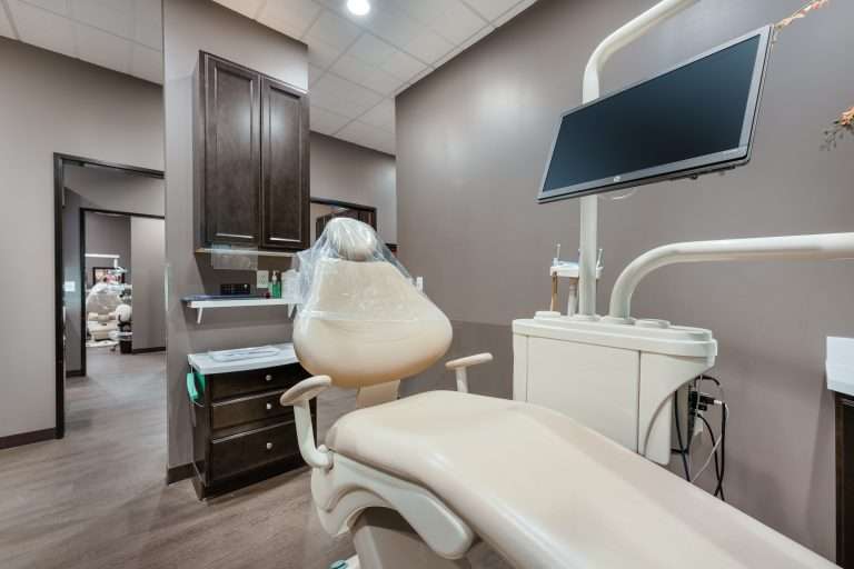 Operatory at Sacramento Dentistry Group with overhead monitor for patient education and diagnostic imaging